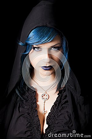 Hooded dark woman with blue hair and lipstick. Key pendant Stock Photo