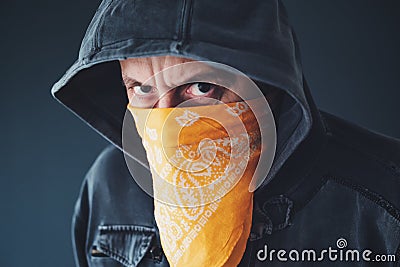 Hooded gang member criminal with scarf over face Stock Photo