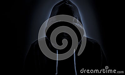 Hooded hacker in dark Stock Photo