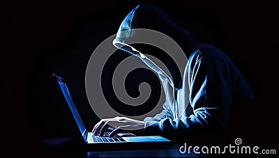 Hooded hacker stealing information from a laptop computer Stock Photo