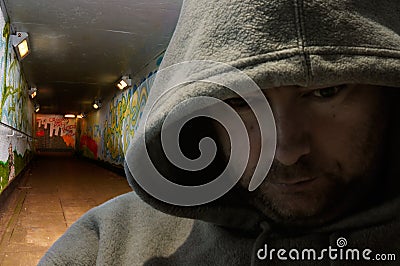 Hooded man in graffiti-decorated subway Stock Photo