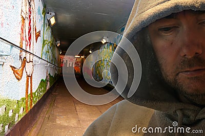Hooded man in graffiti decorated subway Stock Photo