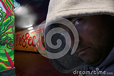 Hooded man in graffiti decorated subway Stock Photo