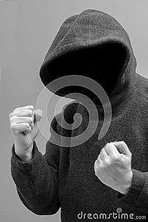 Hooded man intent on violence Stock Photo