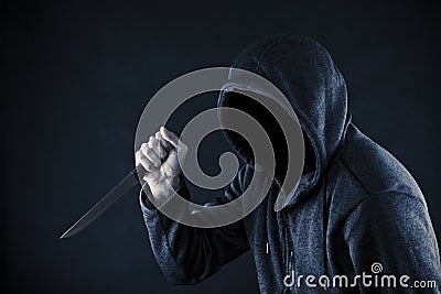 Hooded man with knife Stock Photo