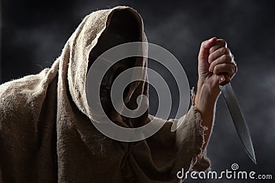 Hooded man with knife Stock Photo