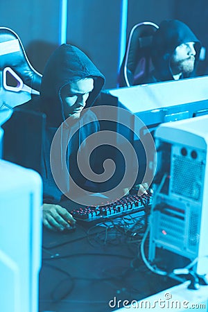 Hooded programmers using powerful computers Stock Photo