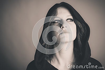 Hooded scheming woman Stock Photo