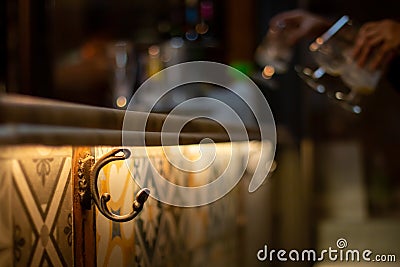 Hook to hang coats on a bar counter. Stock Photo