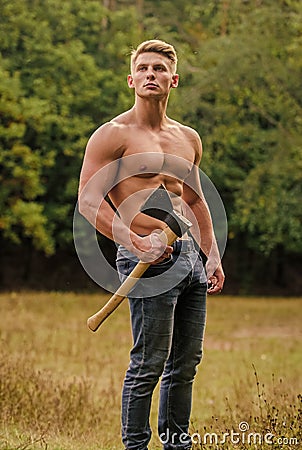 Hooligan man. sexy macho bare torso ax. brutal and attractive male in wood. bodybuilder show his muscles. power and Stock Photo