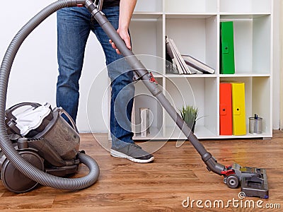 Hoovering a parquet floor Stock Photo