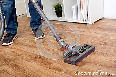 Hoovering a parquet floor wooden Stock Photo