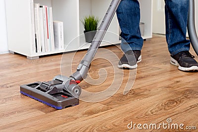Hoovering a parquet Stock Photo