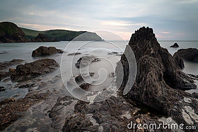 Hope Cove sunset landscape seascape with rocky coastline and lon Stock Photo