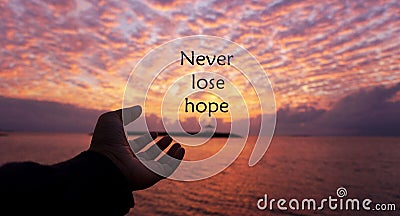 Hope Inspirational quote - Never lose hope. With one human hand open reaching the sun arise. With dramatic colorful sunrise sunset Stock Photo