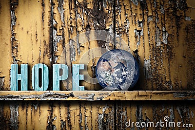 Hope text word and planet Earth on worn wooden background Stock Photo