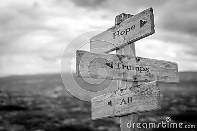 hope trumps all text quote on wooden signpost Stock Photo