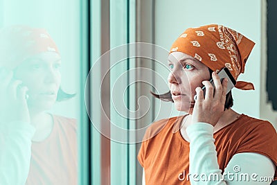 Hopeful female carpenter talking on mobile phone Stock Photo