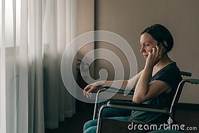 Hopeful female person with disability talking on mobile phone Stock Photo