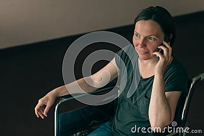 Hopeful female person with disability talking on mobile phone Stock Photo