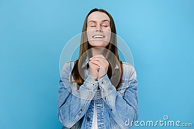 Hopeful young female clenching fists making wish praying asking dreams come true, wishful woman in anticipation Stock Photo