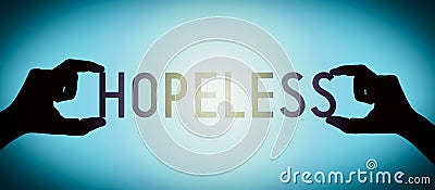 Hopeless - human hands holding black silhouette word Stock Photo