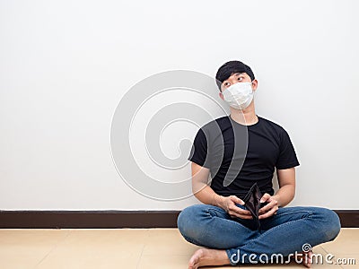 Man sit on floor with wallet no money,Poor man disheartened Stock Photo