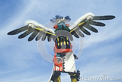 Hopi Kachina doll with outstretched winged arms against blue sky Stock Photo