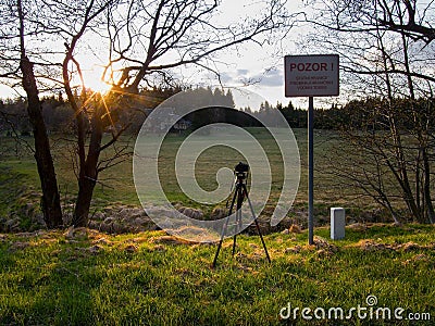 Hora Svateho Sebestiana, Czech republic - April 27, 2020: camera and stativ bei Cerna creek between czech and german landscape in Editorial Stock Photo