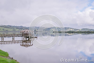 Horeke Hokianga Harbour and pier on a cloudy overcast day, in Fa Stock Photo
