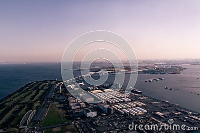 A horizontal aerial view of the Tokyo Gate Bridge in Tokyo Bay from a helicopter at sunset in spring Stock Photo