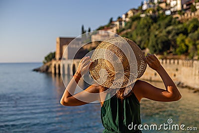 Travelling to Alanya. Backview portait of a young fit female in Stock Photo