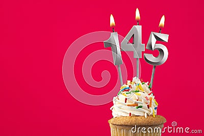 Burning candle number 145 - Birthday card with cupcake Stock Photo