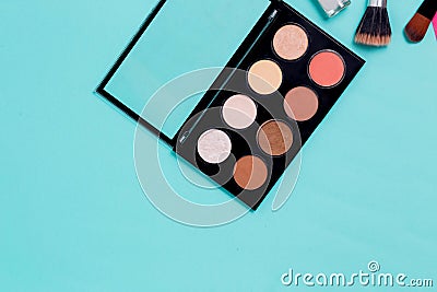 Horizontal blue paper background for text with makeup. Multi colored palette of shadows Stock Photo