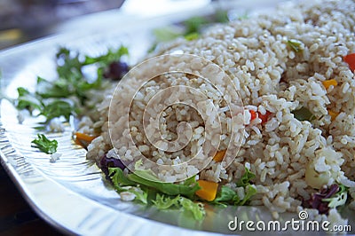 Healthy steamed brown, integral rice with vegetables on a large plate Stock Photo