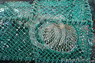 Horizontal closeup of colorful weathered prawn traps on a dock in western Scotland Stock Photo