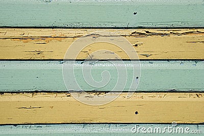 Horizontal green and yellow stripes painted on timber cladding. Stock Photo