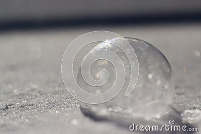 Horizontal image of frozen bubble in sparkly snow Stock Photo