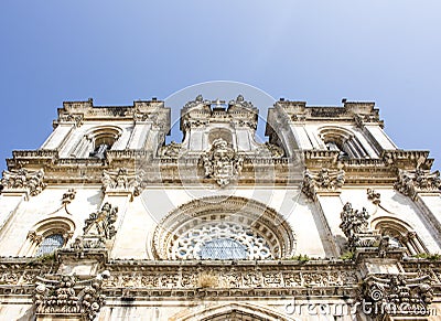 Low-angle shot of the facade of Alcobaca Monastery, or Mosteiro de Santa Maria de Alcobaca, in Portugal. No people. Stock Photo