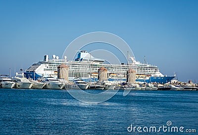 Big cruiser behind ancient mills in capital town of Rhodes island Stock Photo