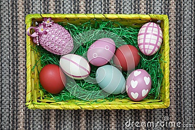 Horizontal photo of an Easter nest / Easter basket with colorful pastel eggs. Stock Photo