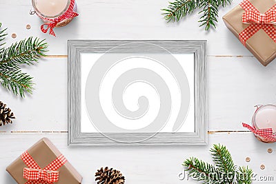 Horizontal photo frame surrounded with Christmas New Year gifts, tree branches and decorations. Stock Photo