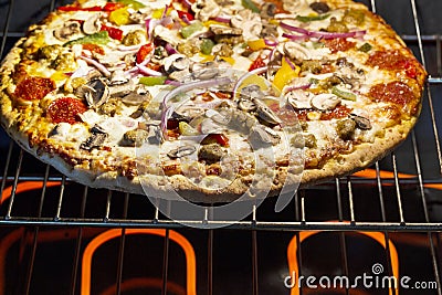 Large fresh pizza baking in oven Stock Photo