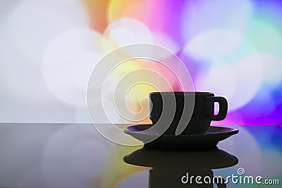 Horizontal photo of silhouette coffee cup on colorful bokeh back Stock Photo