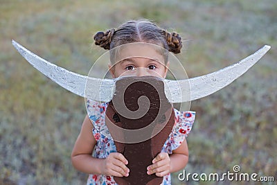 Horizontal photo of a six year old girl who plays outdoors in the summer Stock Photo