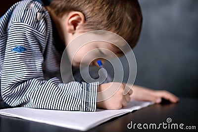 Boy learns to write Stock Photo