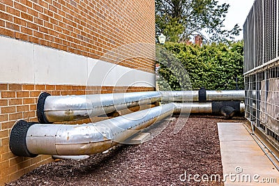 HVAC Pipes Between Outdoor AC Units and Residential Complex Stock Photo