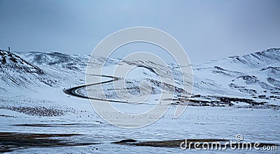 Horizontal shot of S-shaped road surrounded by snow Stock Photo