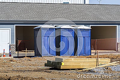Three Porta Potties Or Outdoor Toilets At New Construction Site Stock Photo