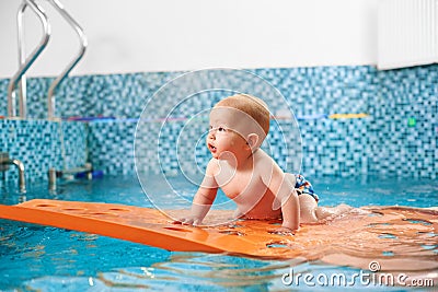 Baby having fun in the swimming pool Stock Photo